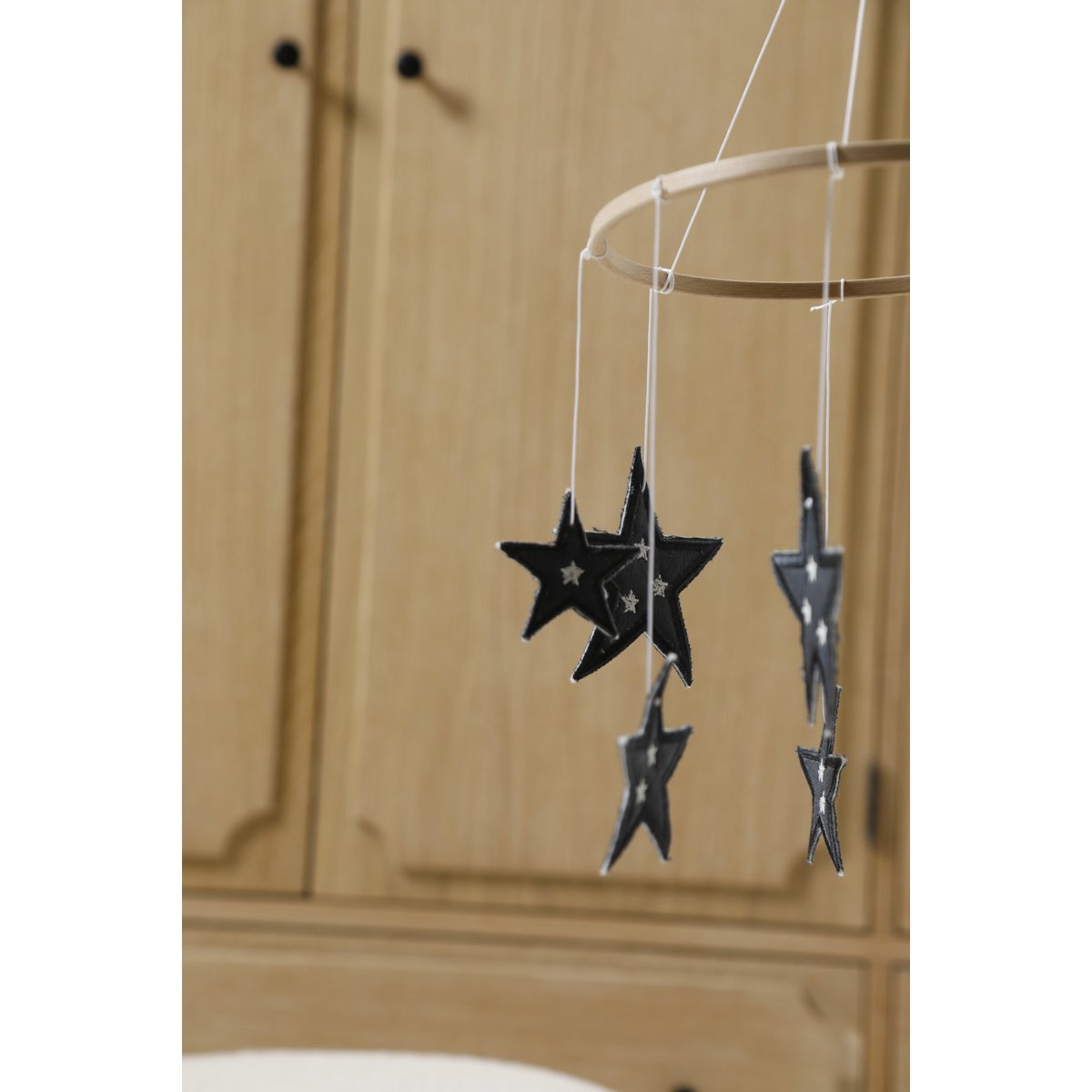 Star-shaped hanging decorations on a wooden cabinet