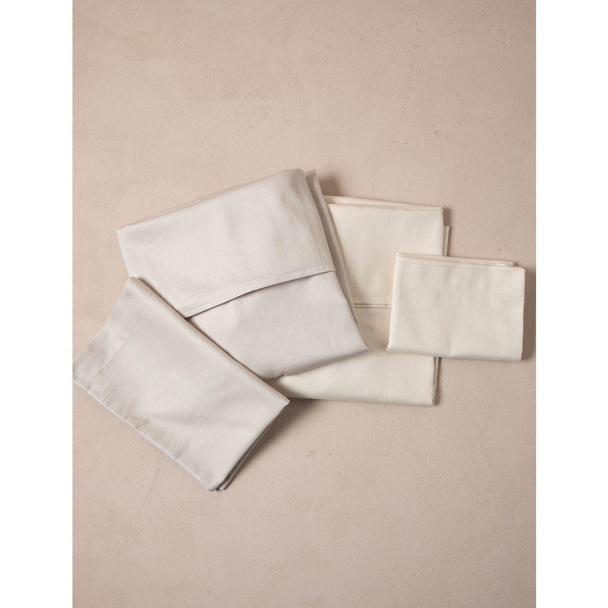 Set of folded beige napkins on a beige background