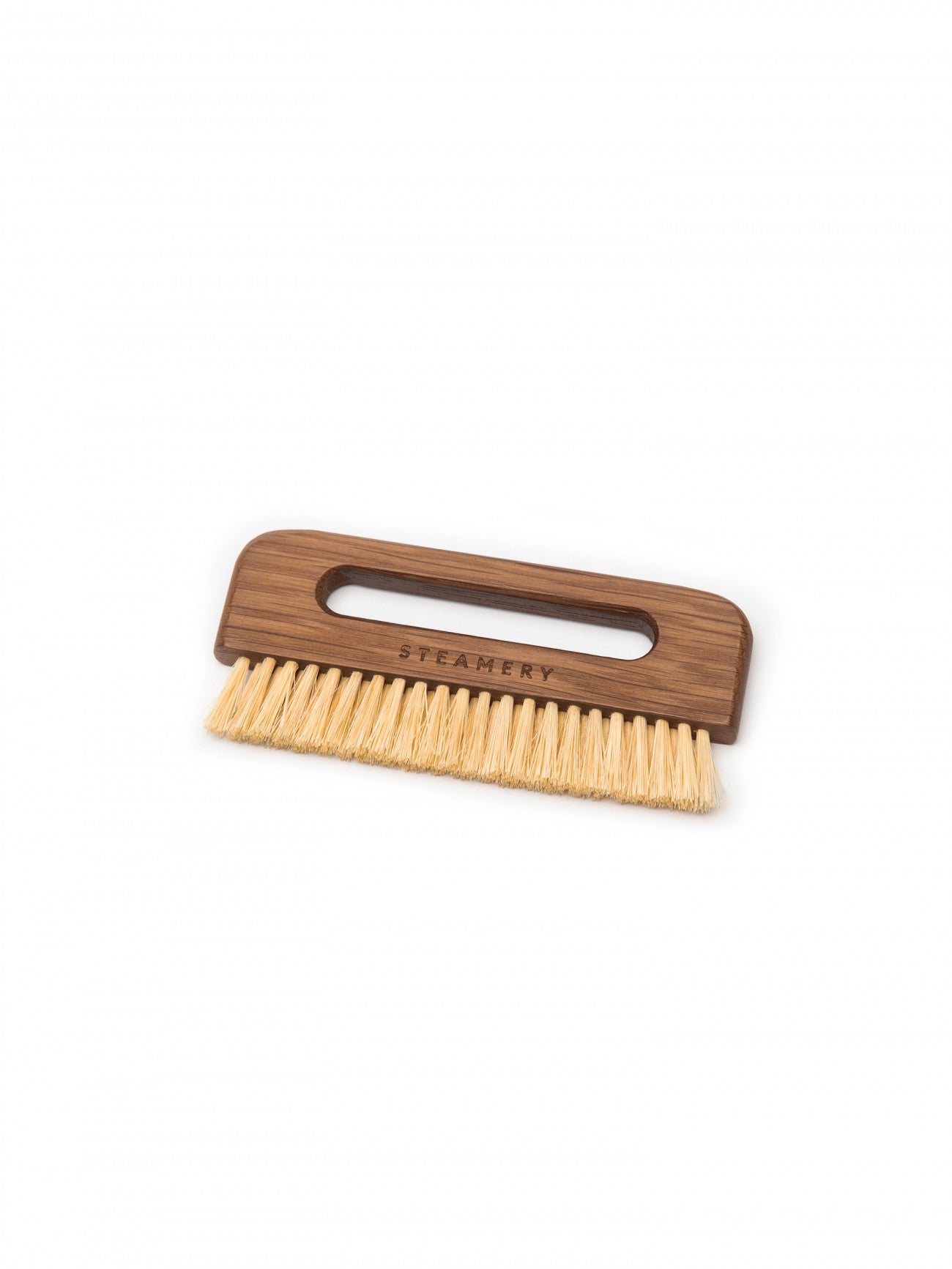 The Steamery Pocket Brush gently removes dust, dirt and hair from your clothes and home textiles