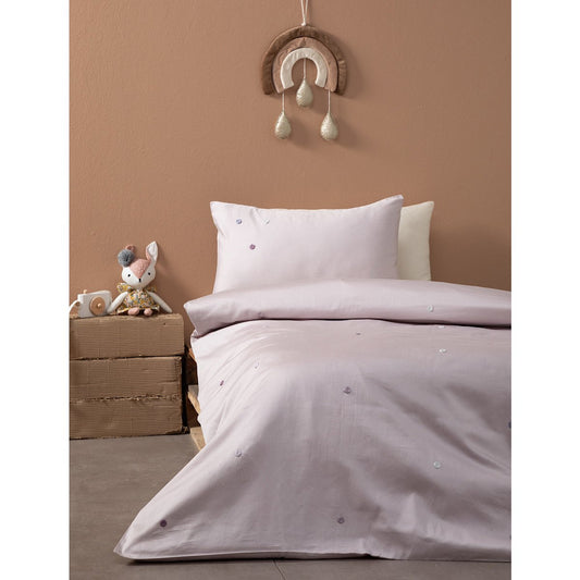 Children's bedroom with pink bedding, toy, and decorative wall hanging on a brown wall.