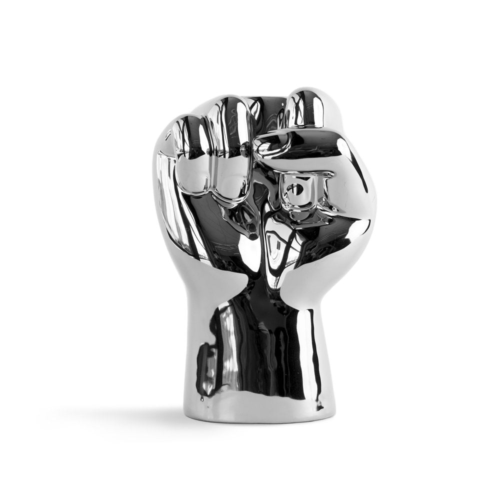 Metallic fist sculpture on a white background