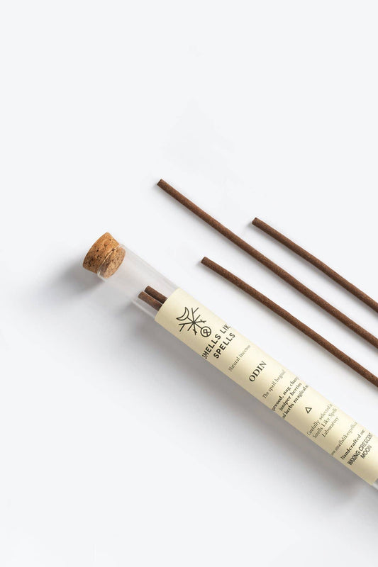 Incense sticks with a cylindrical container on a white background