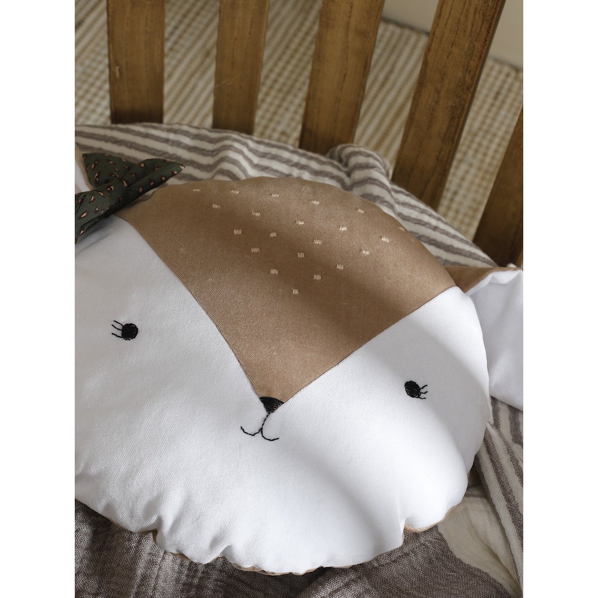 Cushion with a deer design on a wooden chair