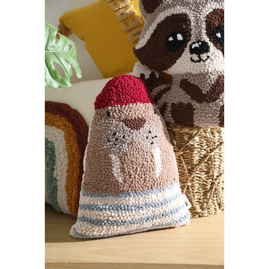 Decorative pillow with a sloth design on a wooden surface