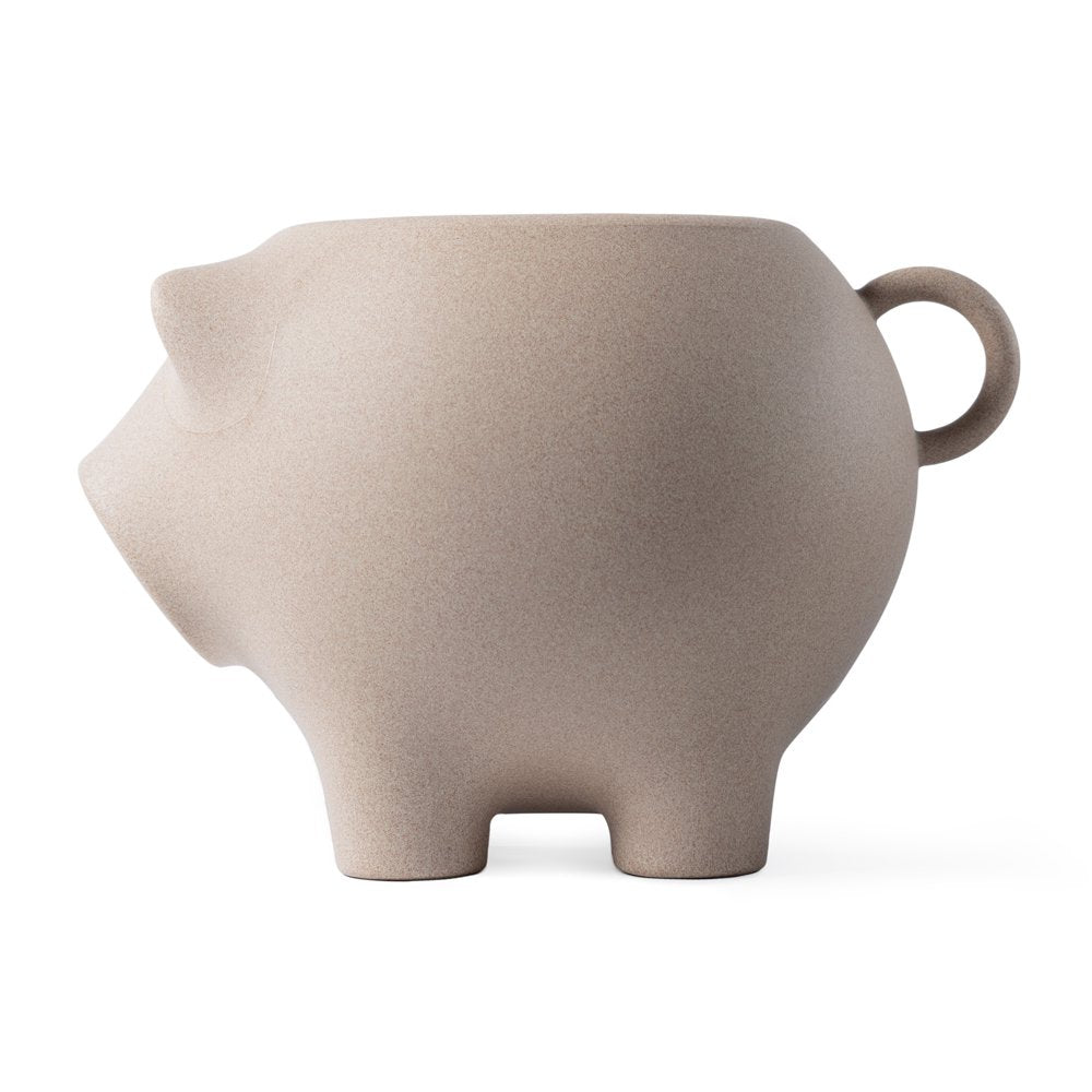 Beige pig-shaped ceramic teapot on a white background