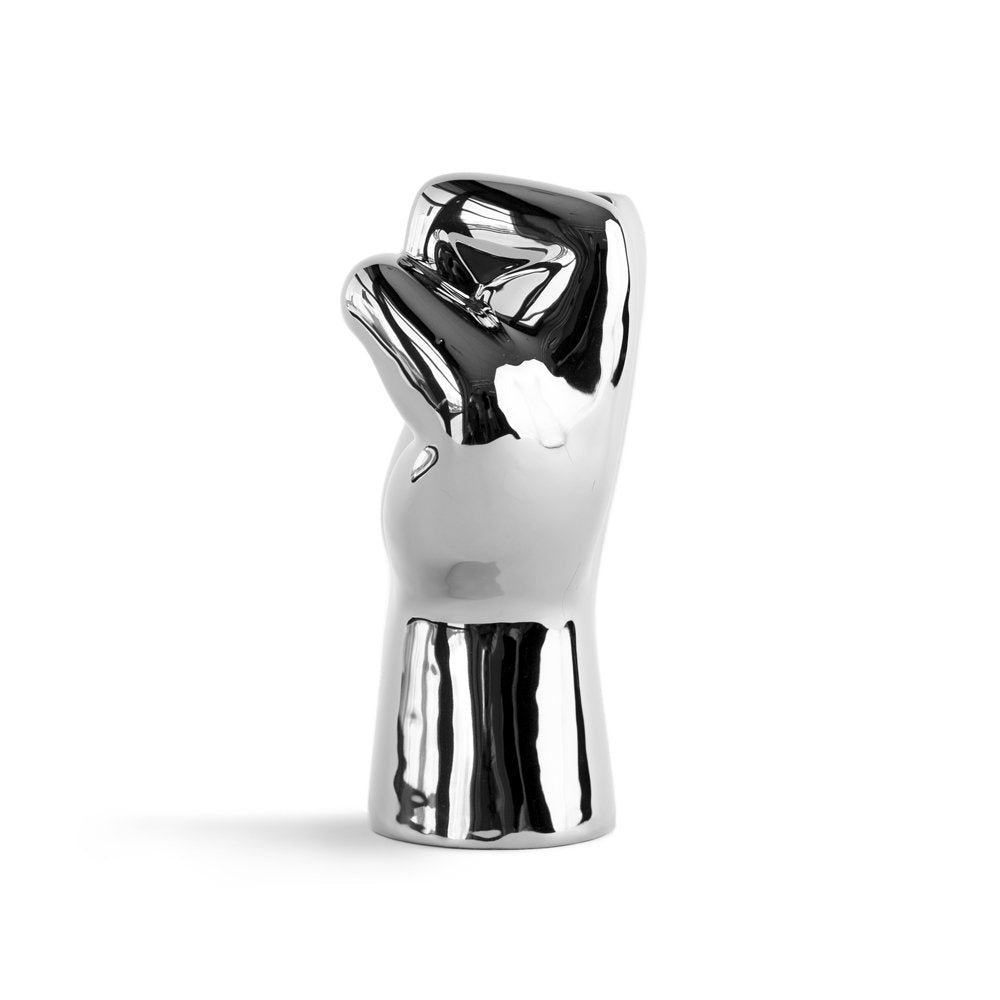 Chrome-finished sculpture of a hand holding a diamond on a white background