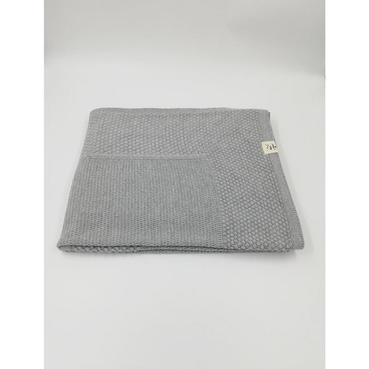 Gray textured blanket with a brand tag on a white background