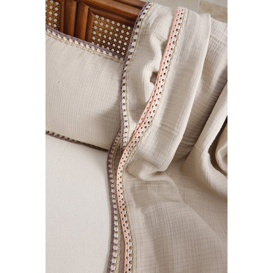 Close-up of a beige fabric with a decorative border on a white background