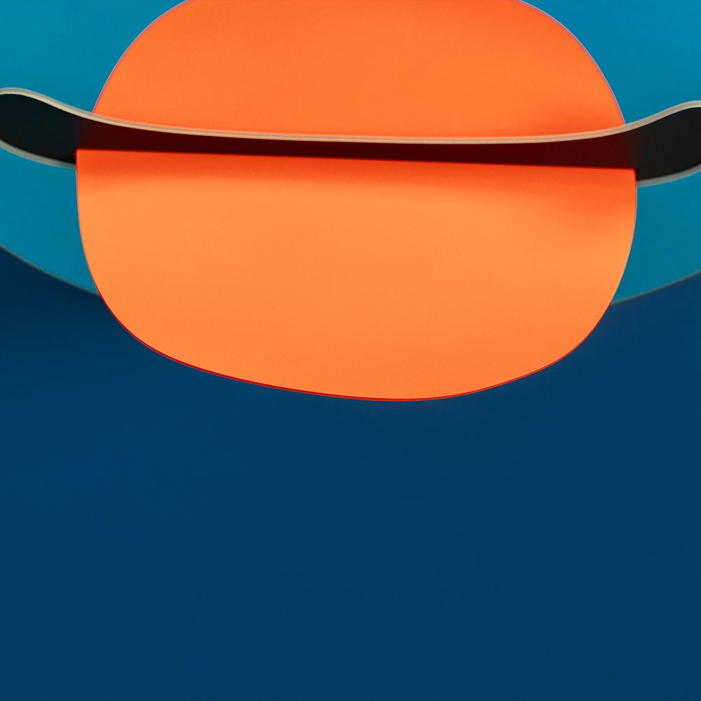 Orange sphere with a black rim on a blue background