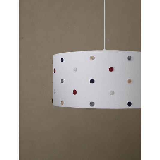 White lampshade with colorful polka dots on a beige background