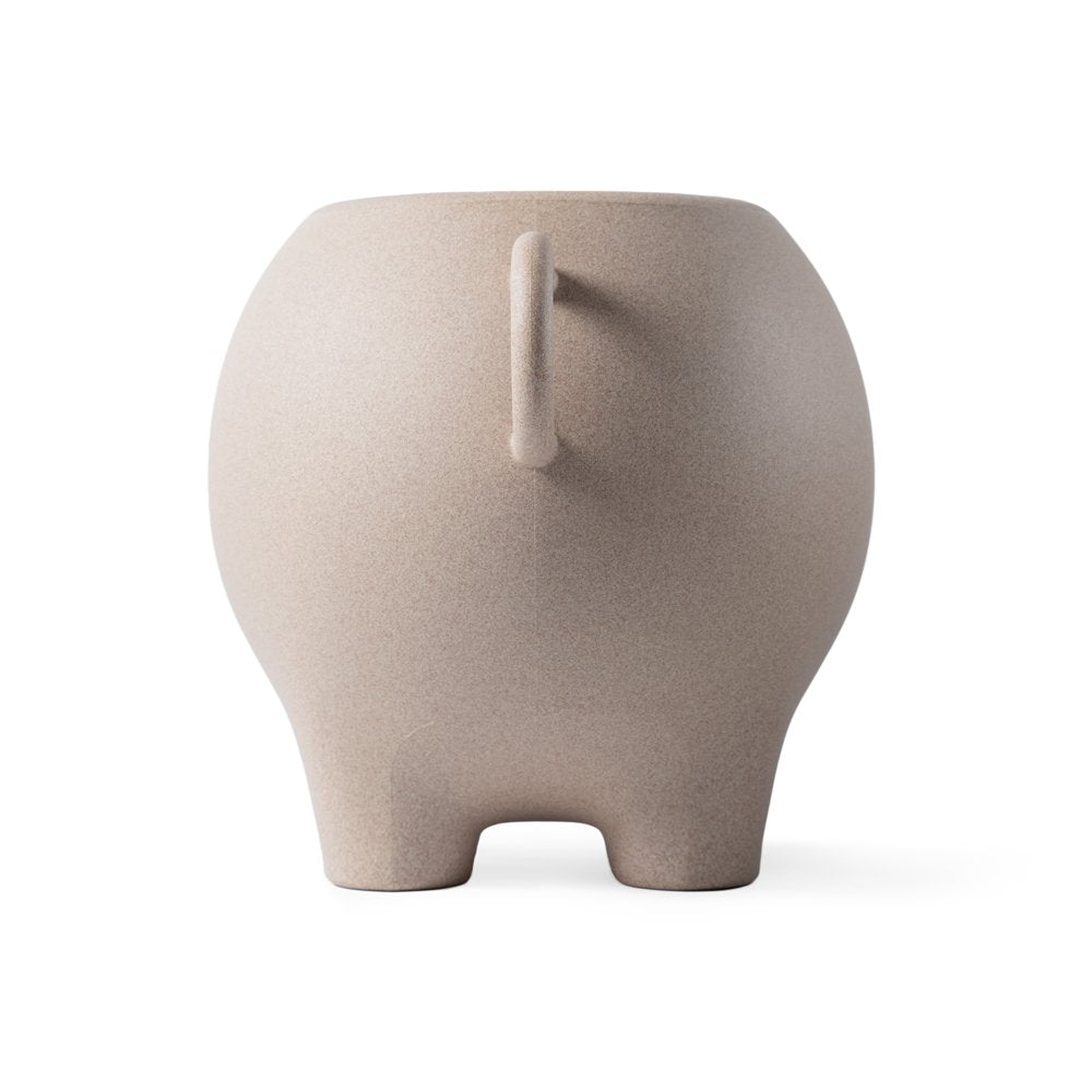 Beige ceramic elephant-shaped object on a white background