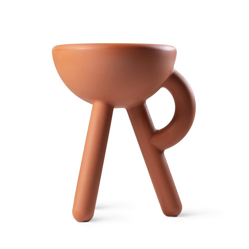 Ceramic cup with handle and three legs on a white background