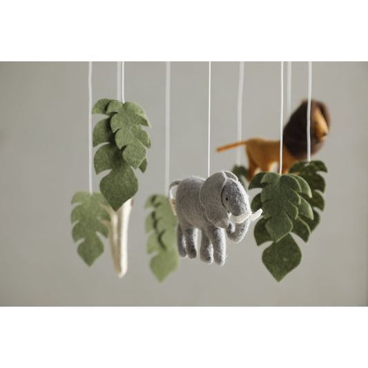 Felt elephant and leaf mobile hanging against a neutral background