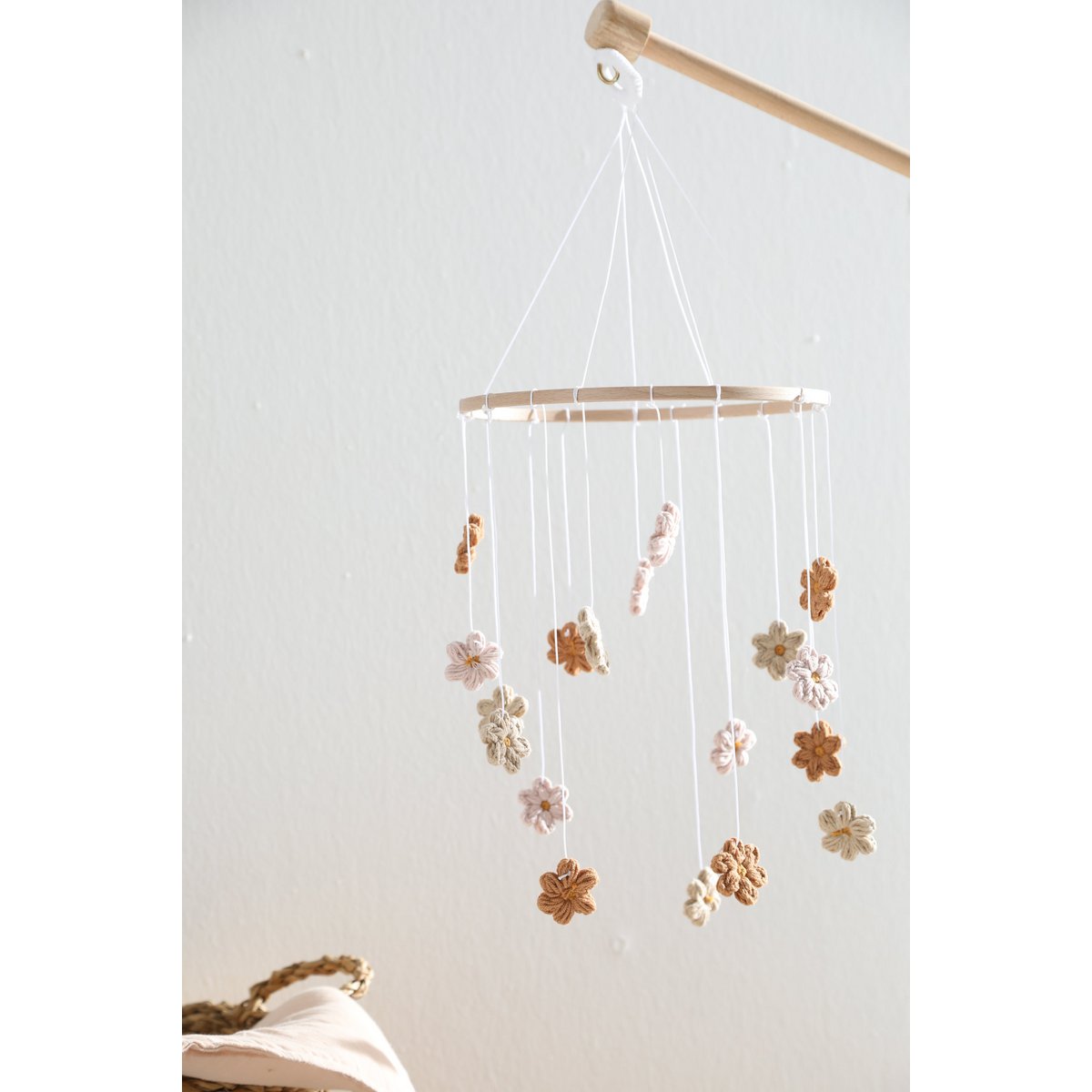 Decorative hanging mobile with flowers against a white wall