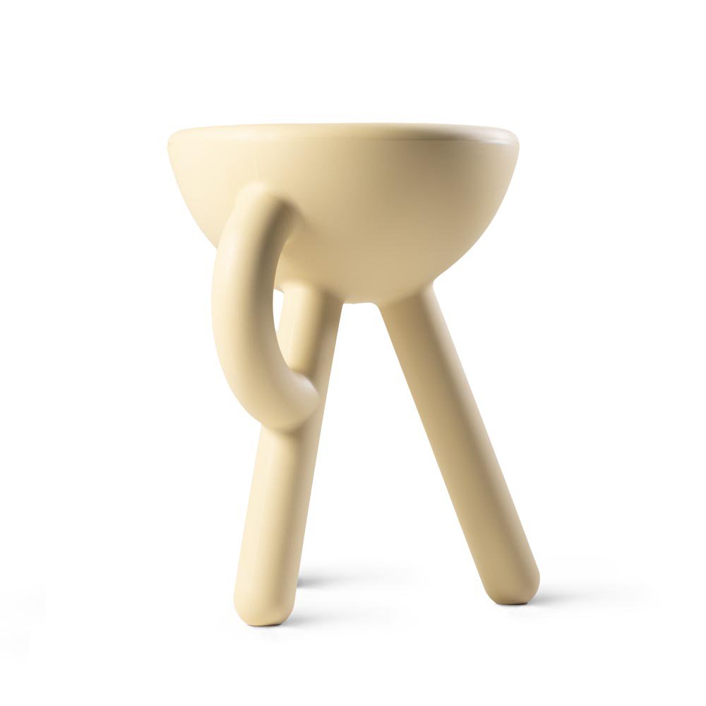 Beige ceramic stool with a unique design on a white background