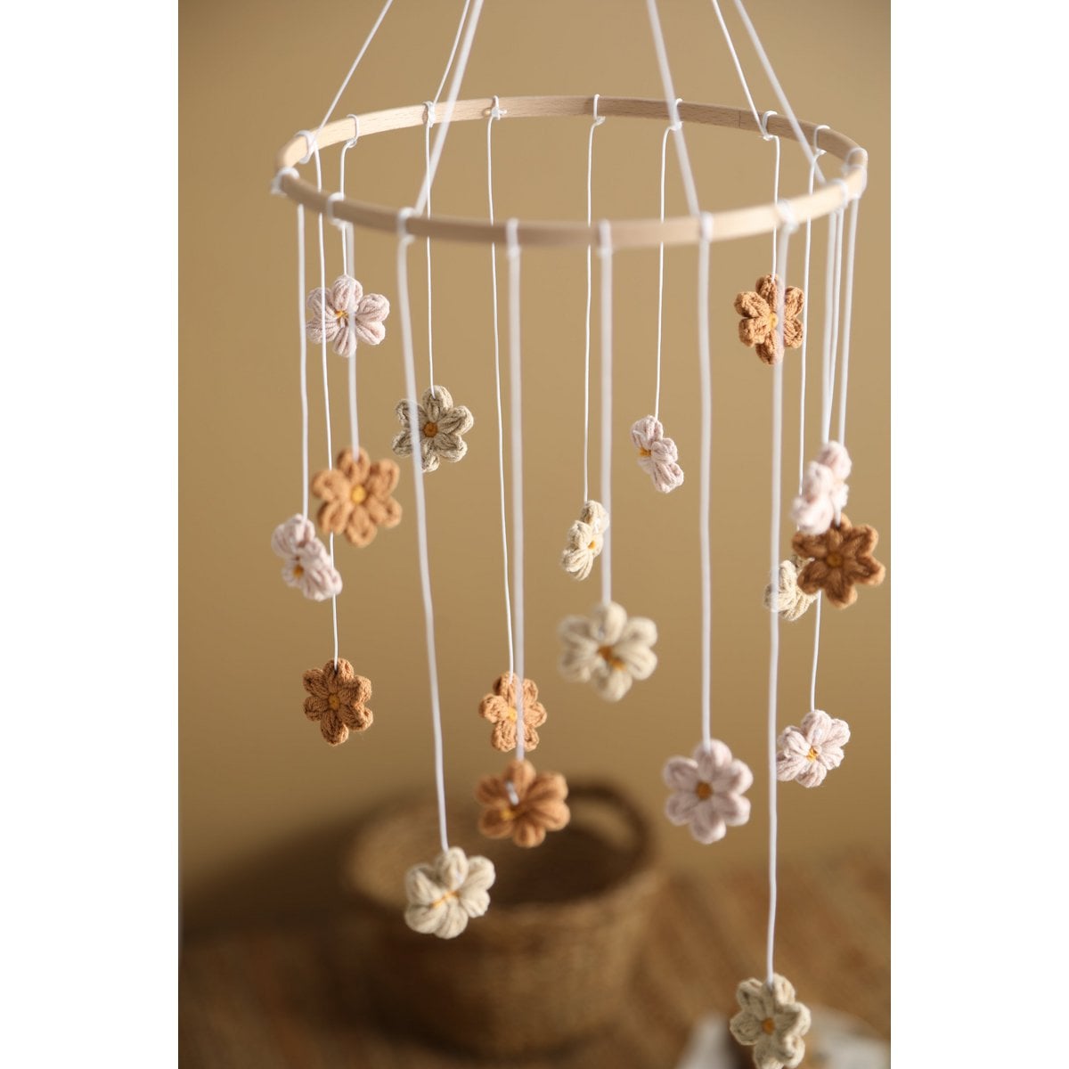 Decorative hanging mobile with flowers against a beige background