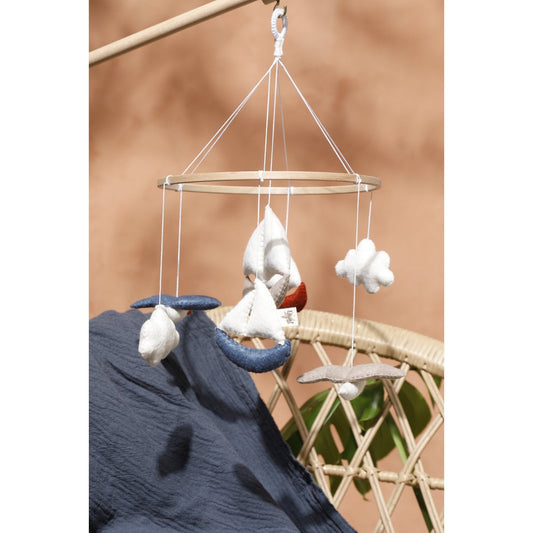 Hanging drying rack with clothes on a beige background
