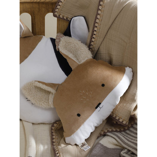 Plush shark toy with a tag on a textured surface