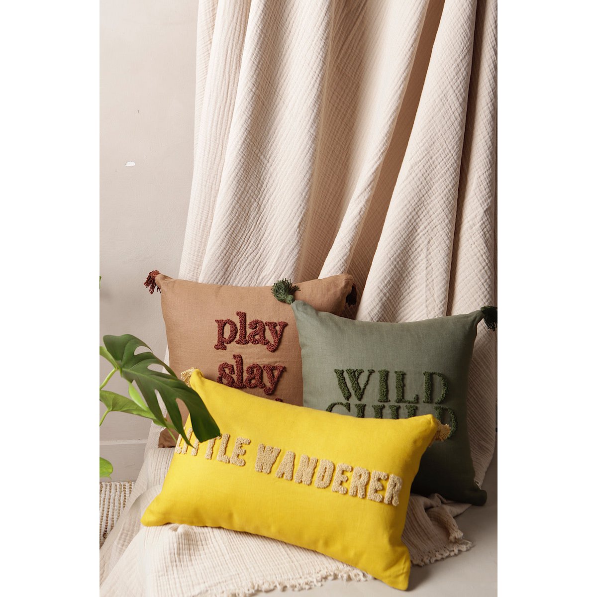 Decorative pillows with text on a neutral background
