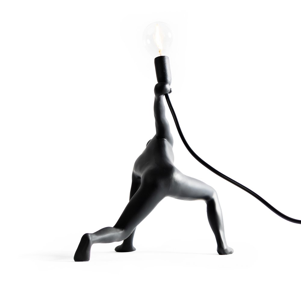 Modern lamp in the shape of a person on a white background