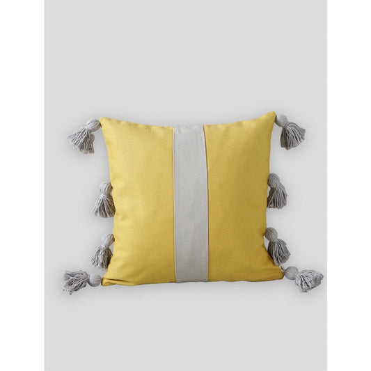 Yellow pillow with a gray stripe and tassels on a white background