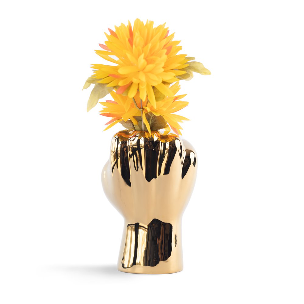 Gold hand-shaped vase with yellow flowers on a white background