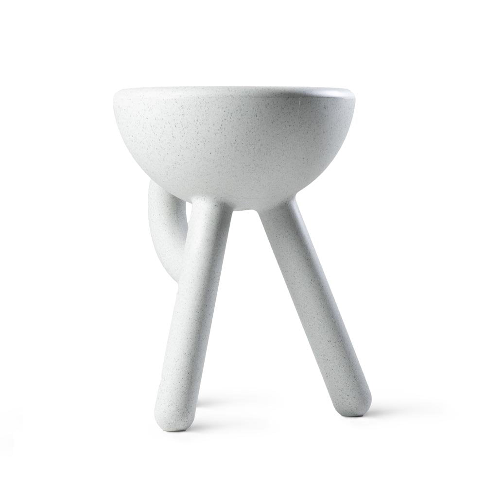 White ceramic bowl with three legs on a white background