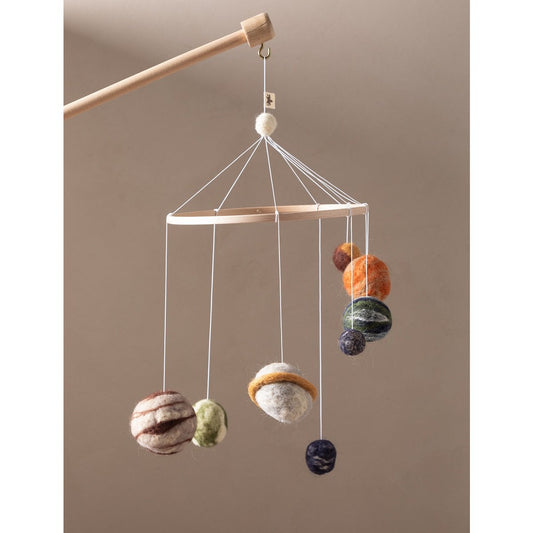 Hanging mobile with colorful spherical elements on a beige background