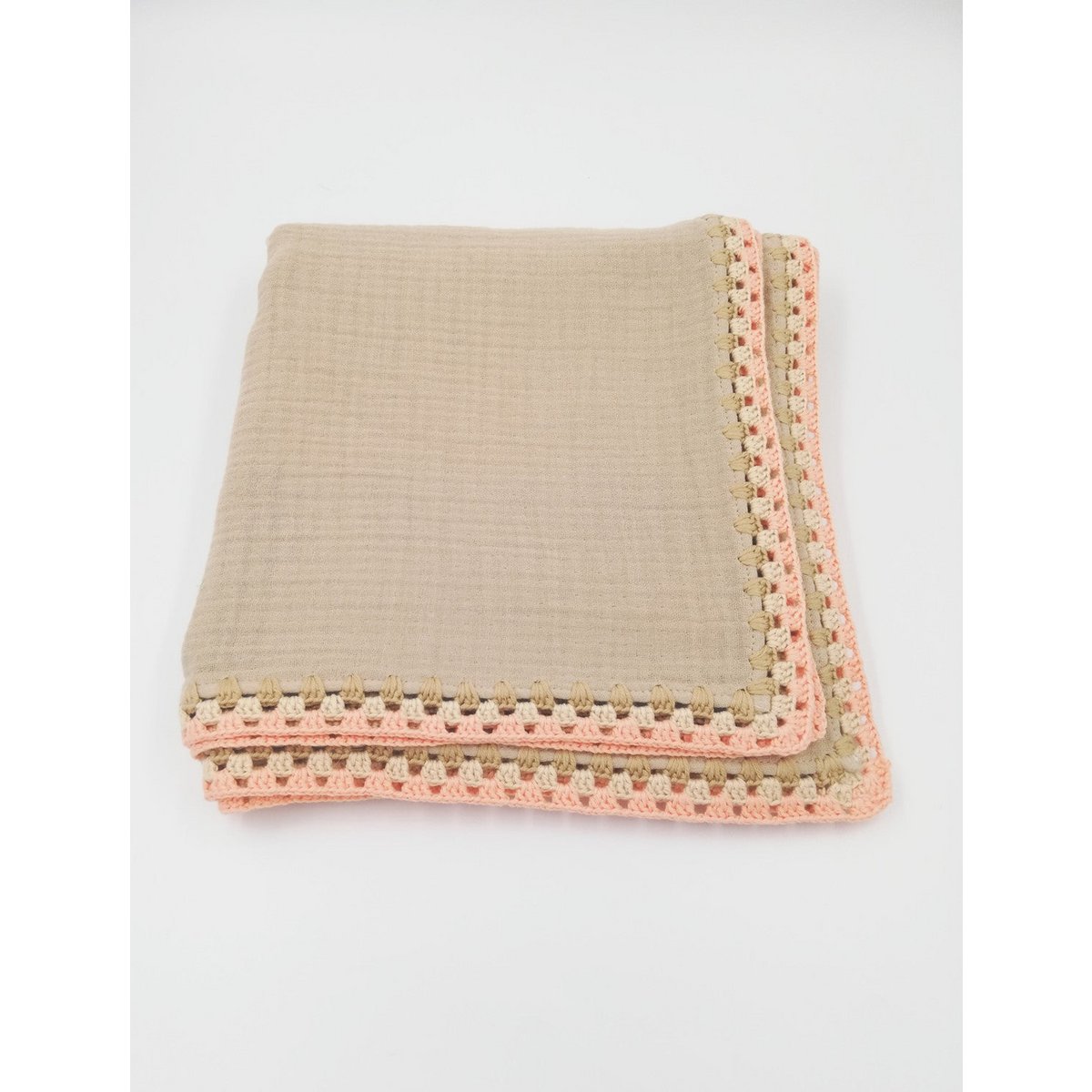Beige blanket with a pink and green crochet border on a white background