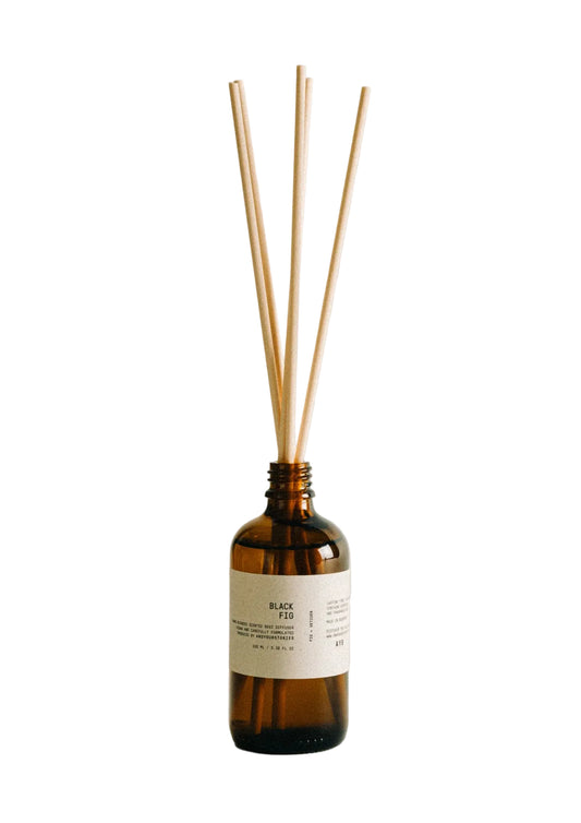 Aromatherapy diffuser with wooden sticks on a light background