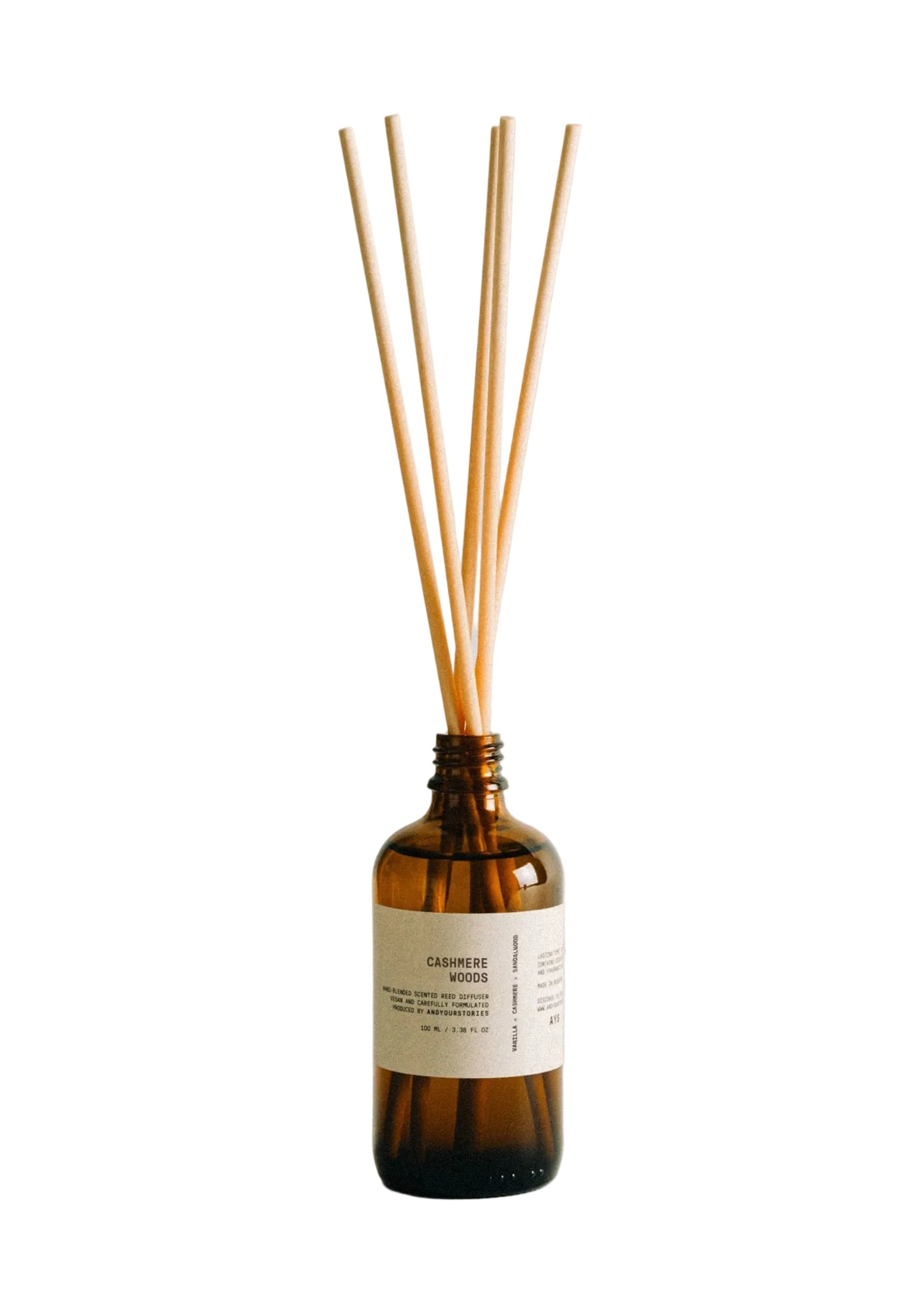 Reed diffuser with wooden sticks in a brown bottle on a light background