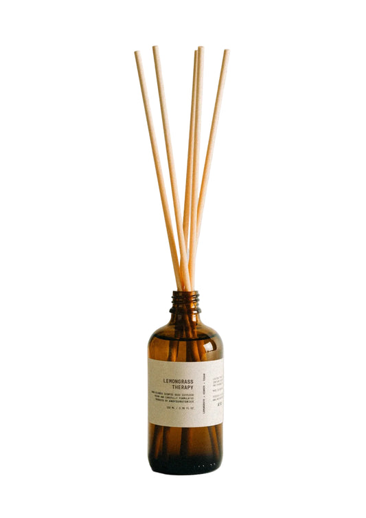 Brown diffuser bottle with wooden sticks by and your stories on a light gray background