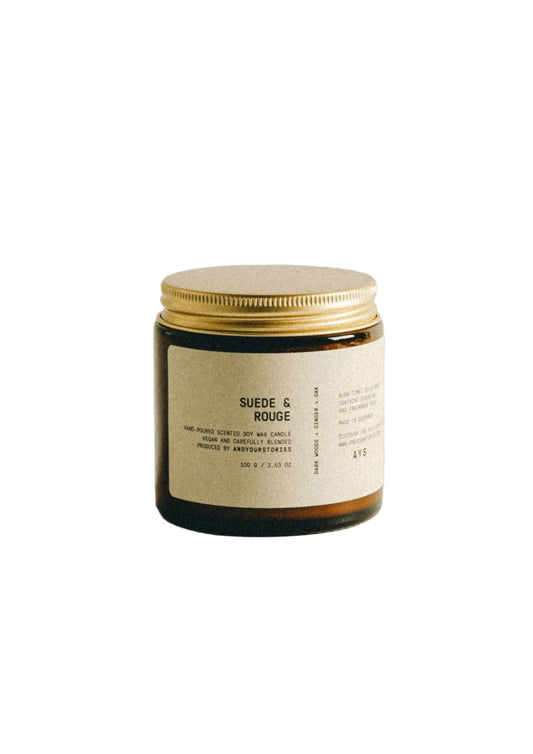 Candle jar with a gold lid on a beige background