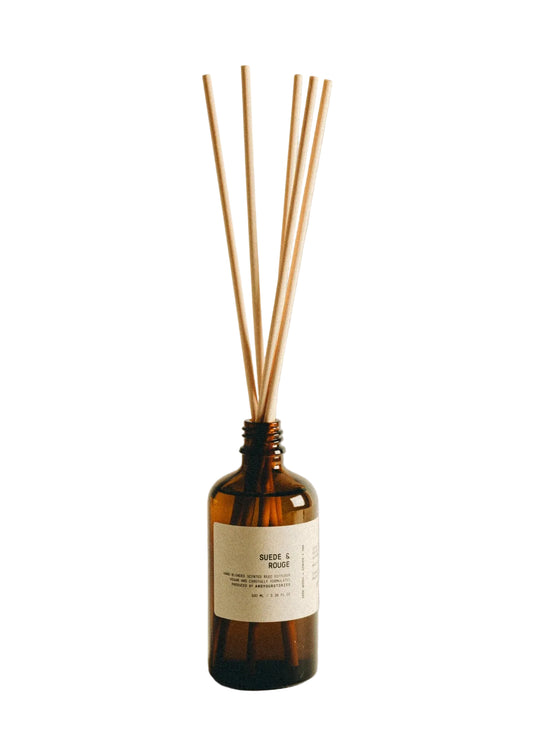Brown diffuser bottle with wooden sticks on a beige background