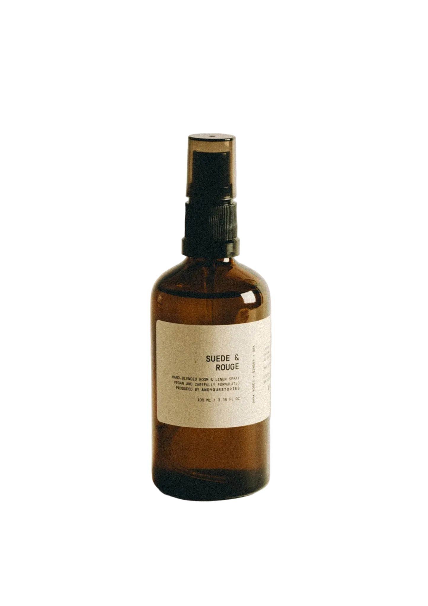 Brown spray bottle with a label on a beige background