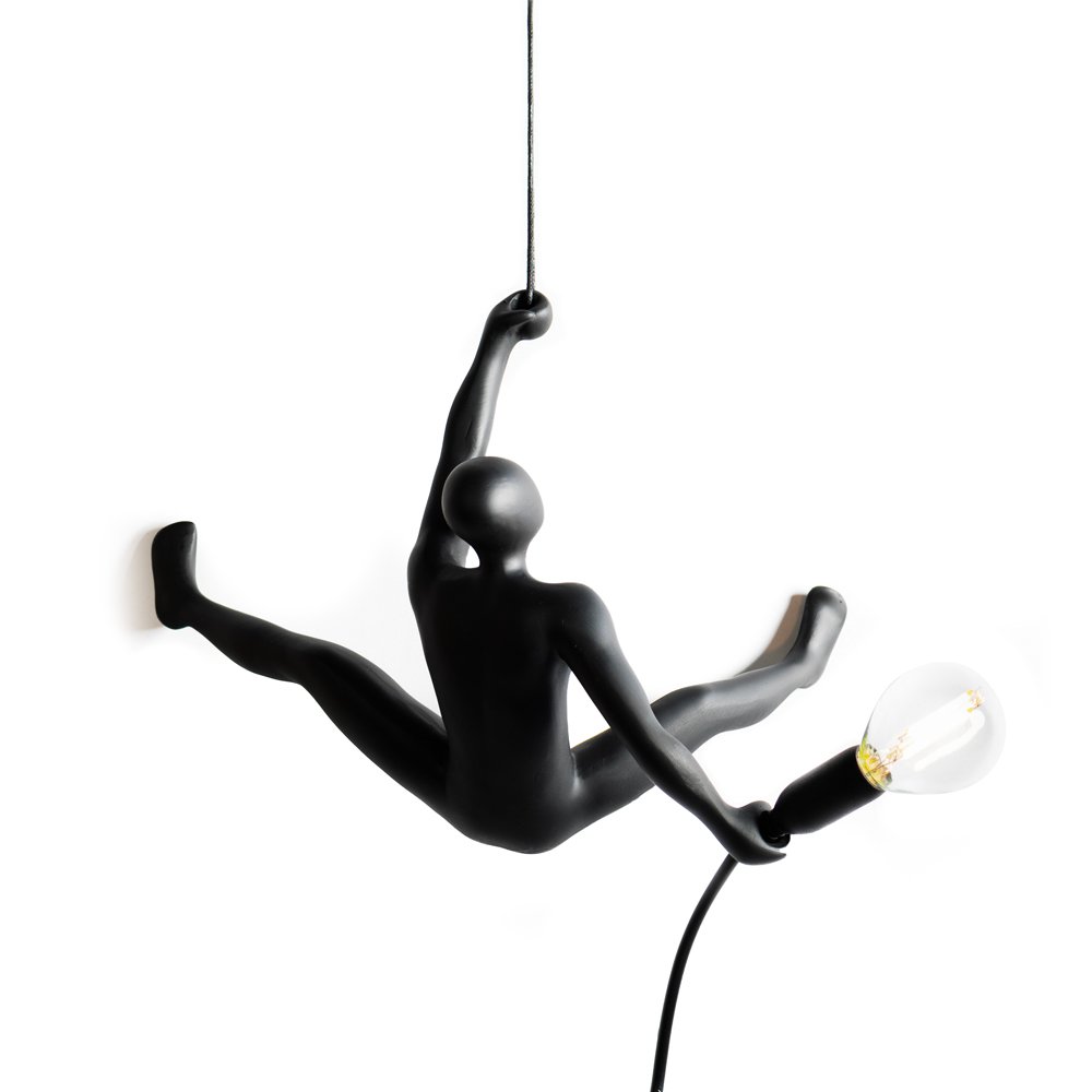 Black pendant lamp shaped like a person climbing a rope with a light bulb.