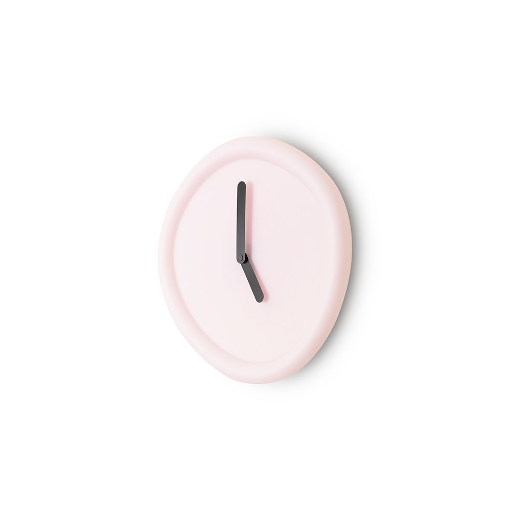 Pink wall clock with a black hour hand on a white background