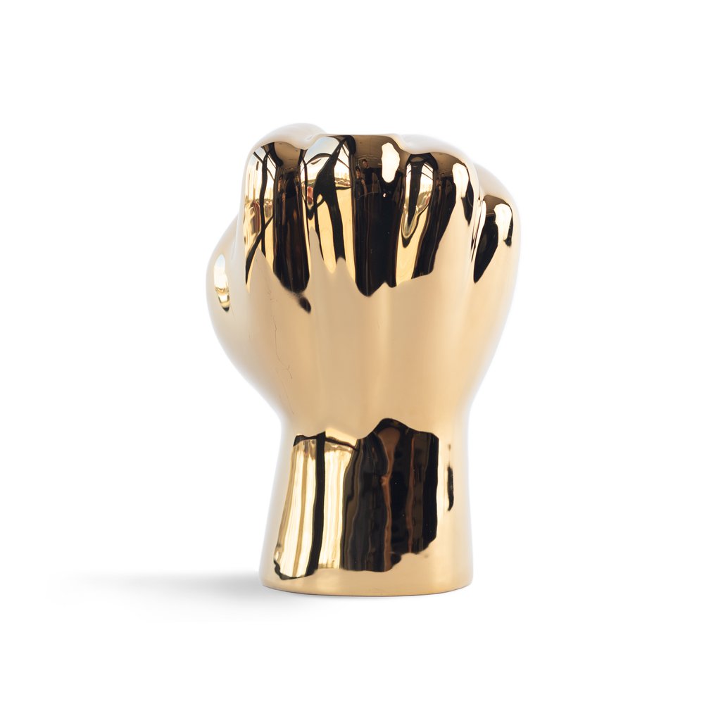 Gold-colored fist-shaped object on a white background