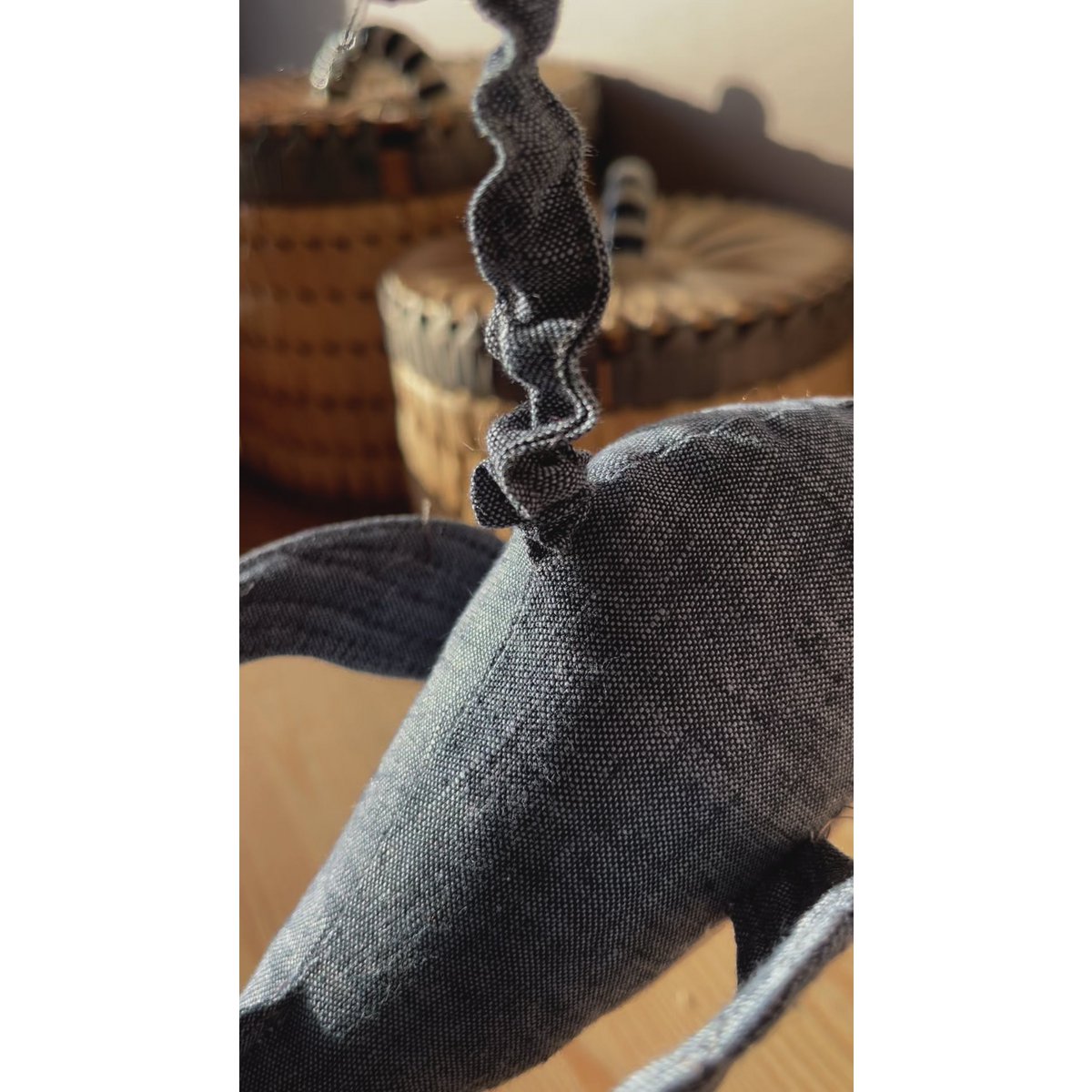 Close-up of a textured gray fabric with a blurred background