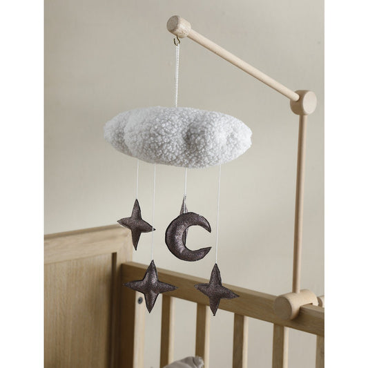Baby mobile with cloud, stars, and moon hanging over a crib.