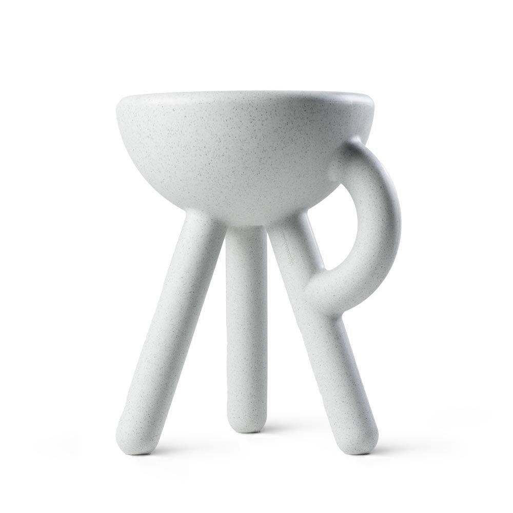 White ceramic stool with a bowl-like seat on a white background