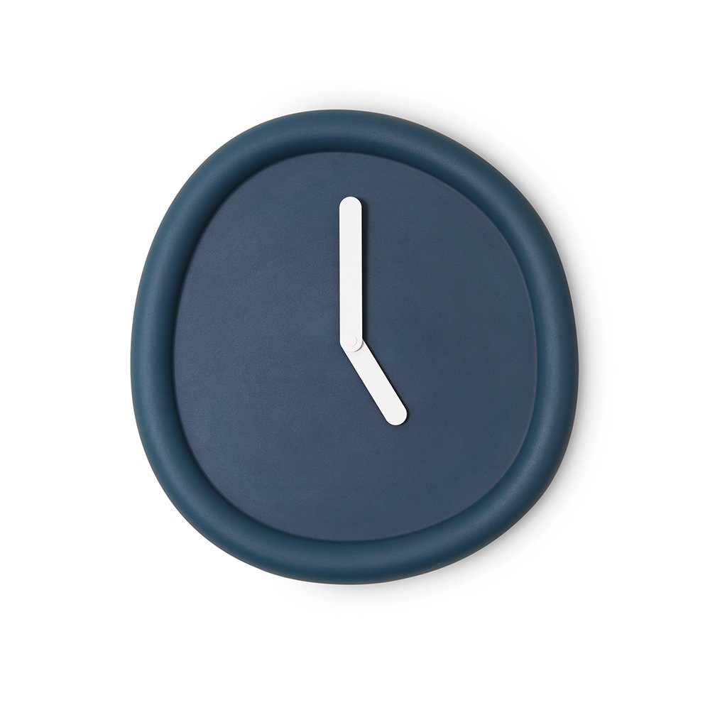 Navy blue wall clock with a white hour hand on a white background