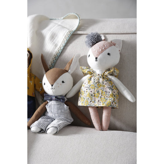 Two plush toys, one rabbit and one bear-like creature, sitting on a light-colored surface.
