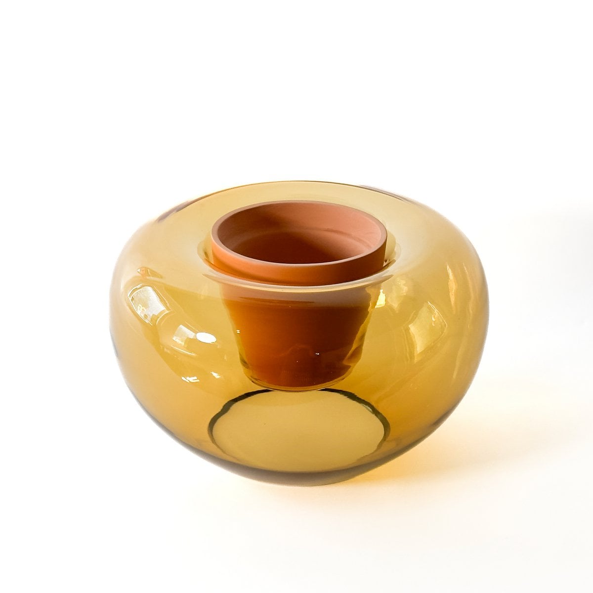 Yellow glass bowl with a brown interior on a white background