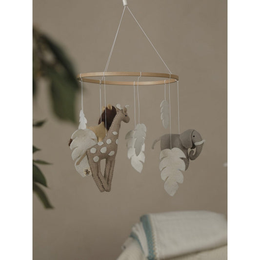 Baby mobile with animal shapes hanging against a neutral background
