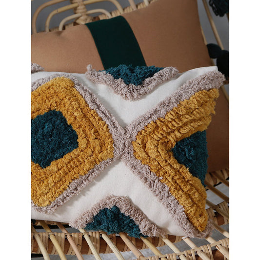 Crocheted blanket with geometric pattern on a wicker chair