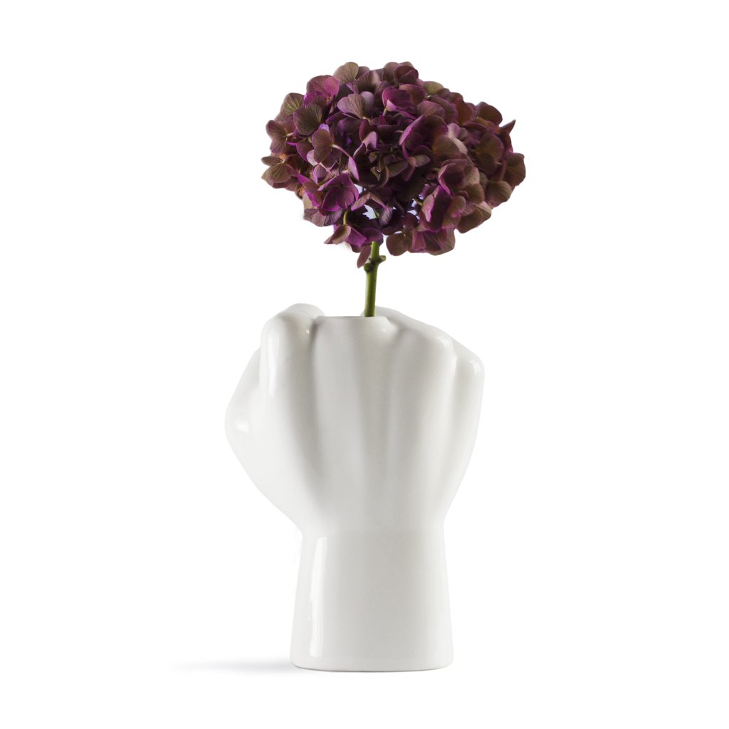 White abstract vase with a purple flower on a white background