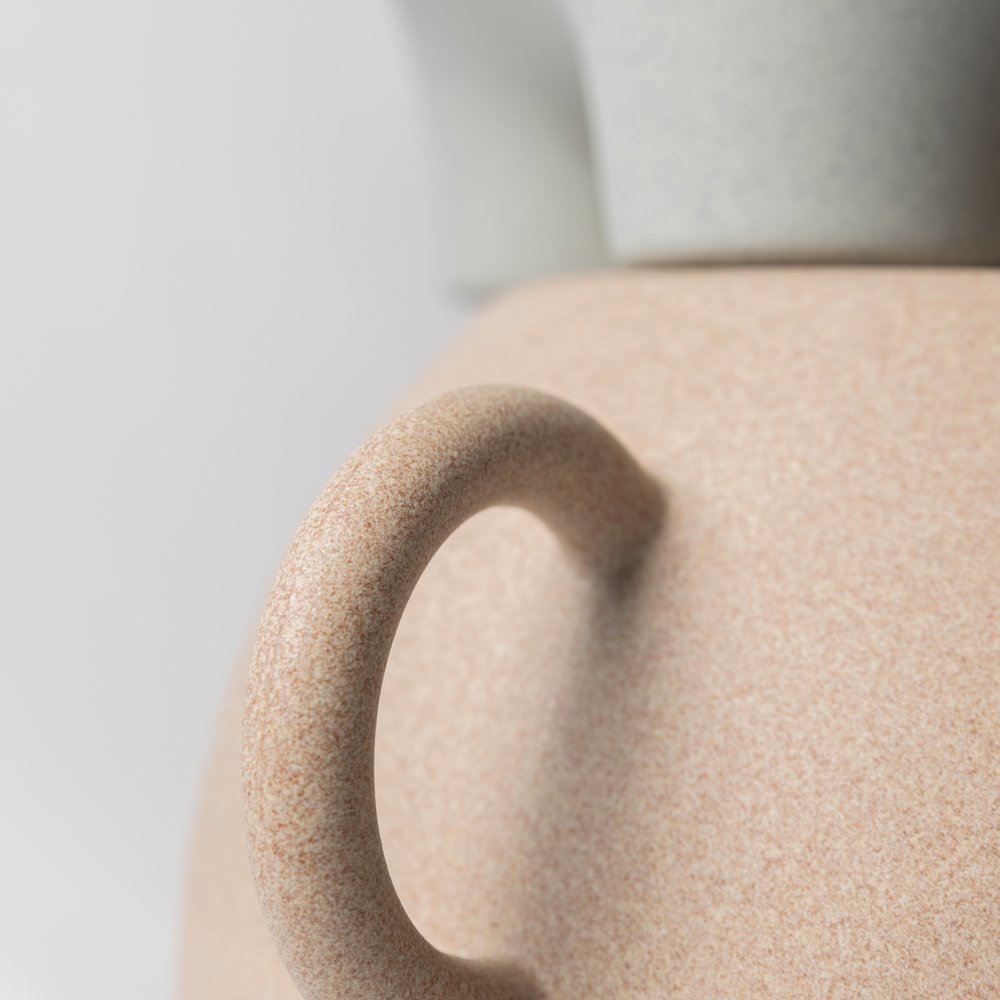 Close-up of a beige ceramic vase with a textured handle on a light gray background