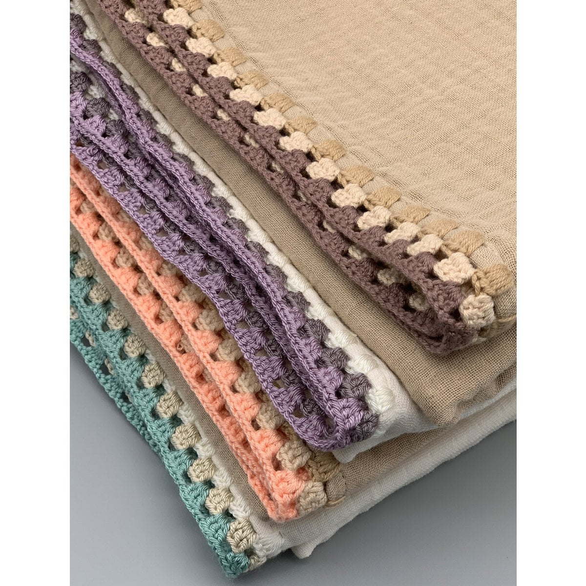 Stack of fabric with different color patterns on a neutral background