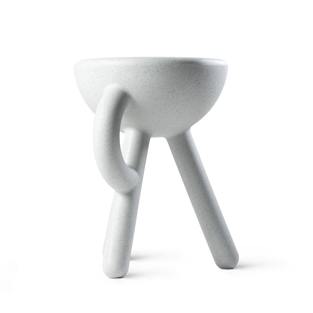 White ceramic bowl with three legs on a white background